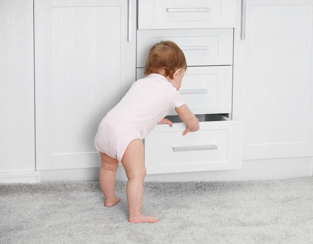 baby playing with drawer
