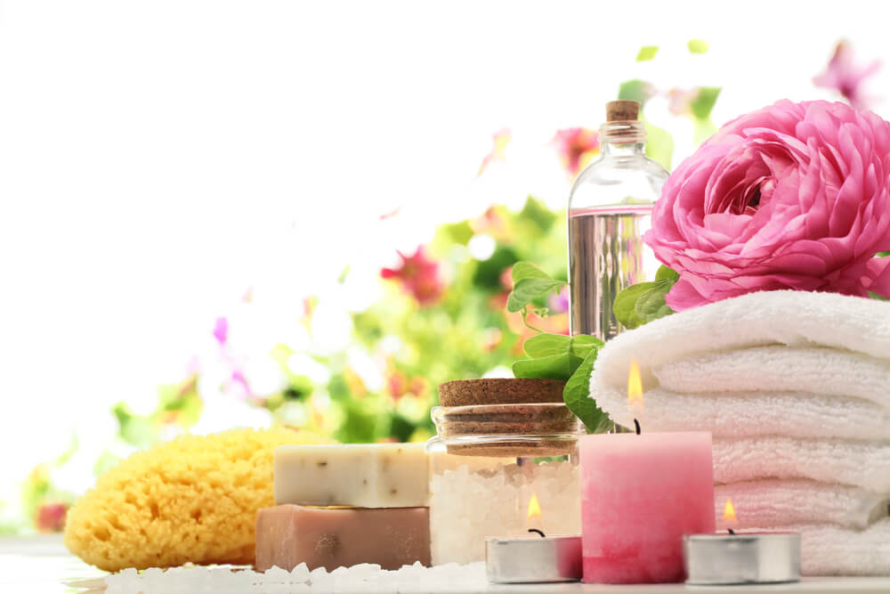 Spa and bath accessories with sponge, soap and towel.