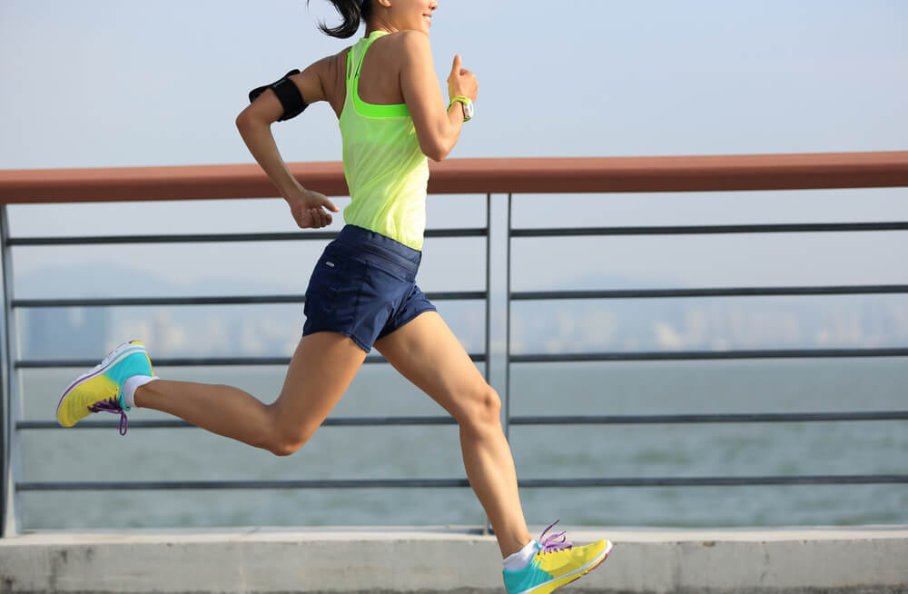 woman runner running at seaside