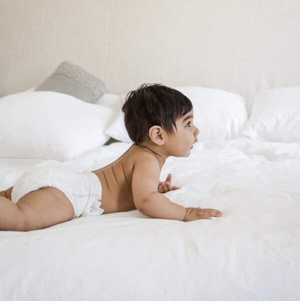 Baby playing on bed