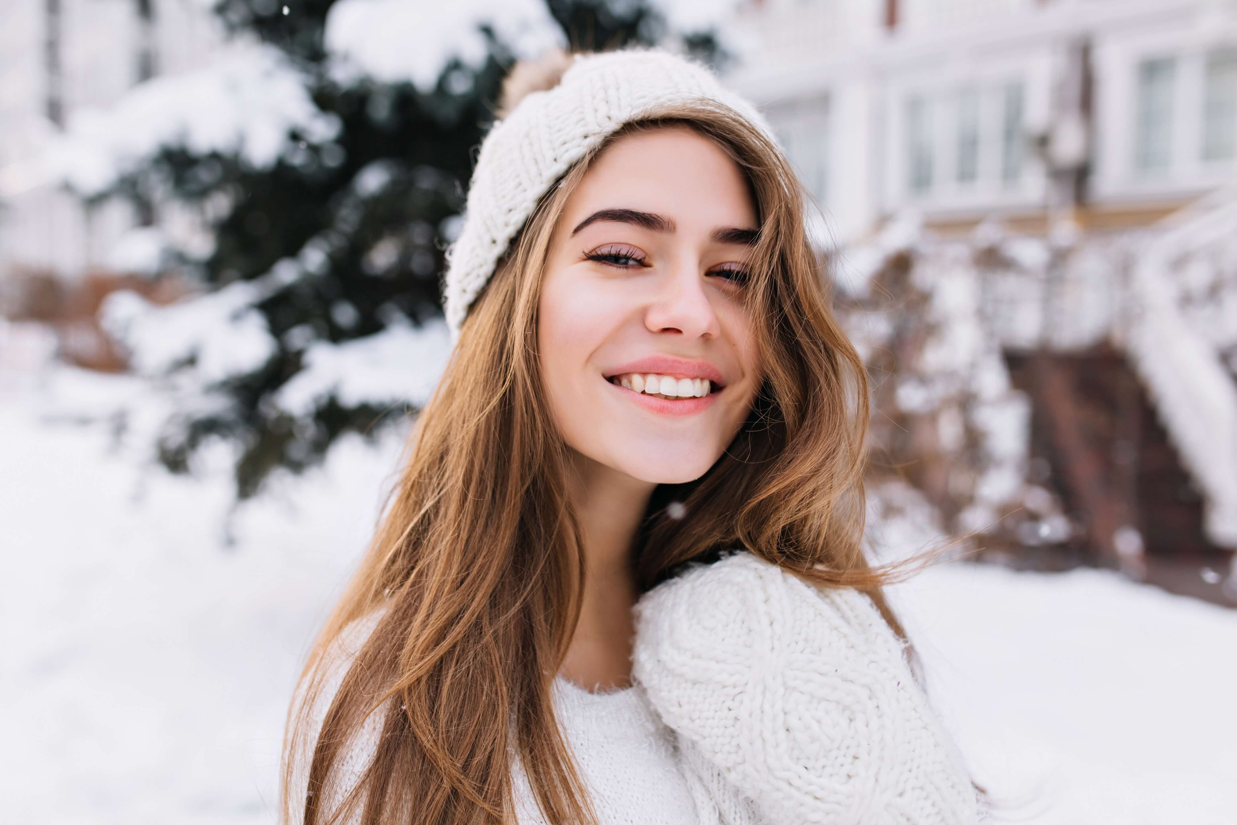 Girl with long hair outside in winter with snow