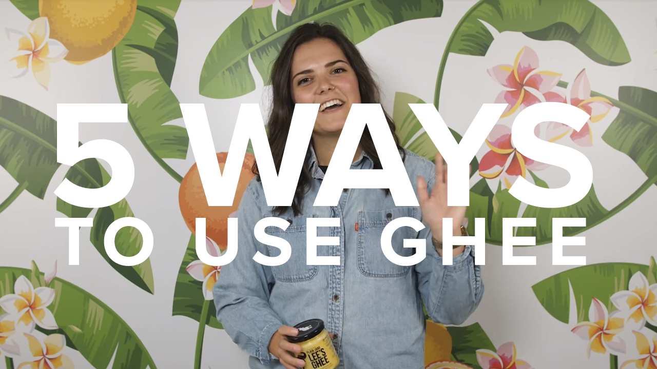 Girl smiling while holding jar of ghee