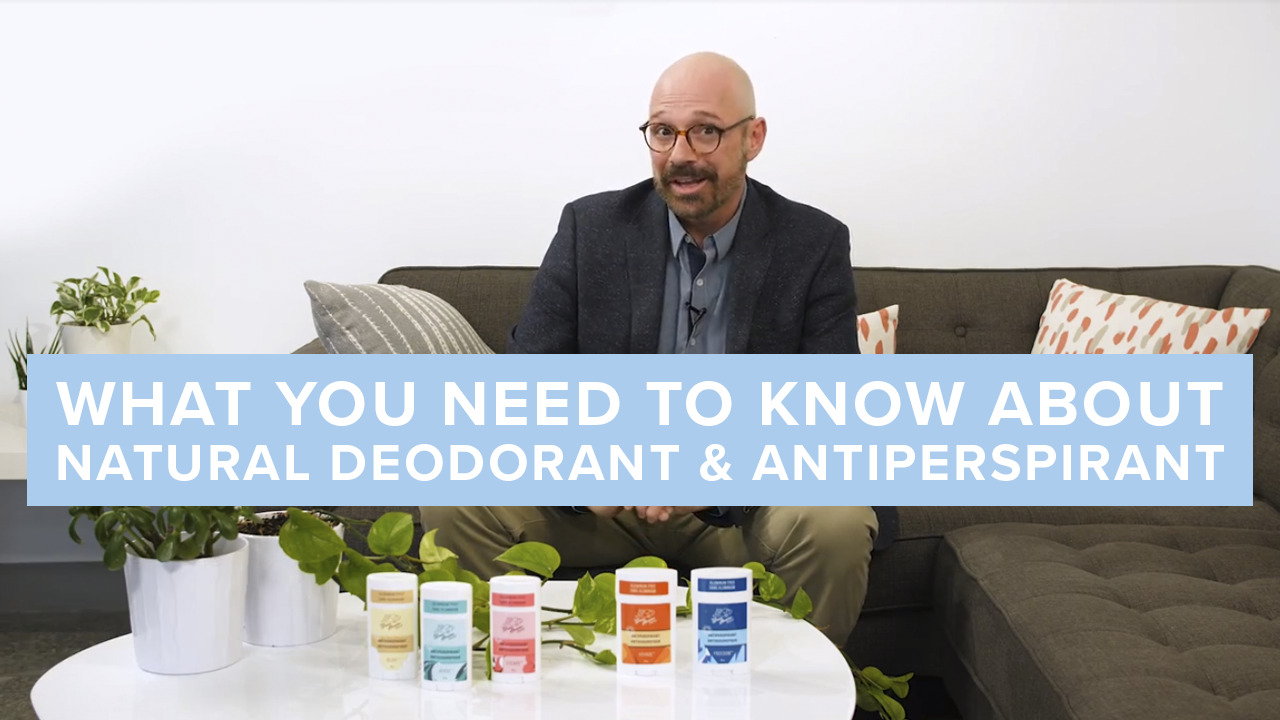 Person talking to camera while deodorants on a table below them