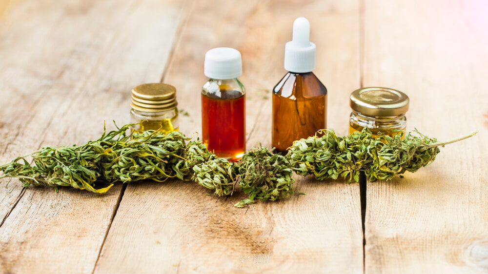 Cannabis oil bottles and flowers