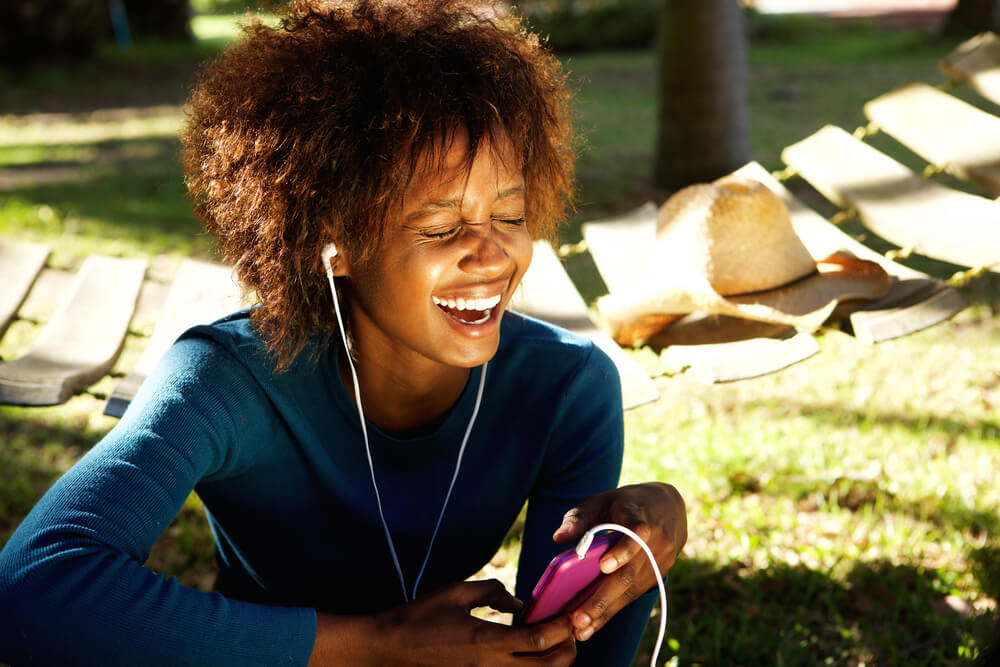 Girl with headphones in laughing