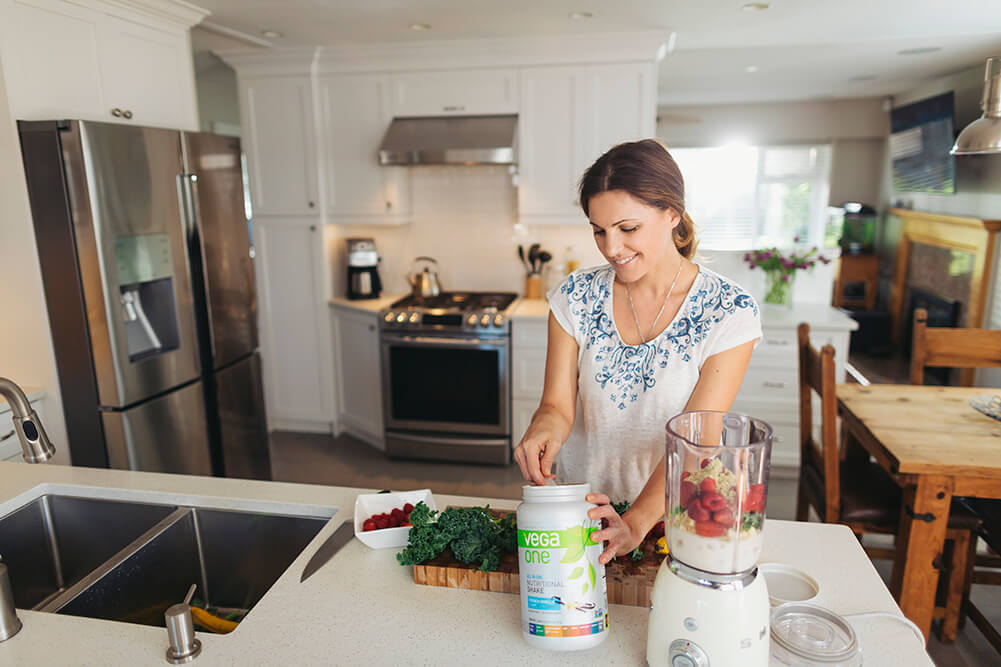 Woman making smoothie in a kitchen