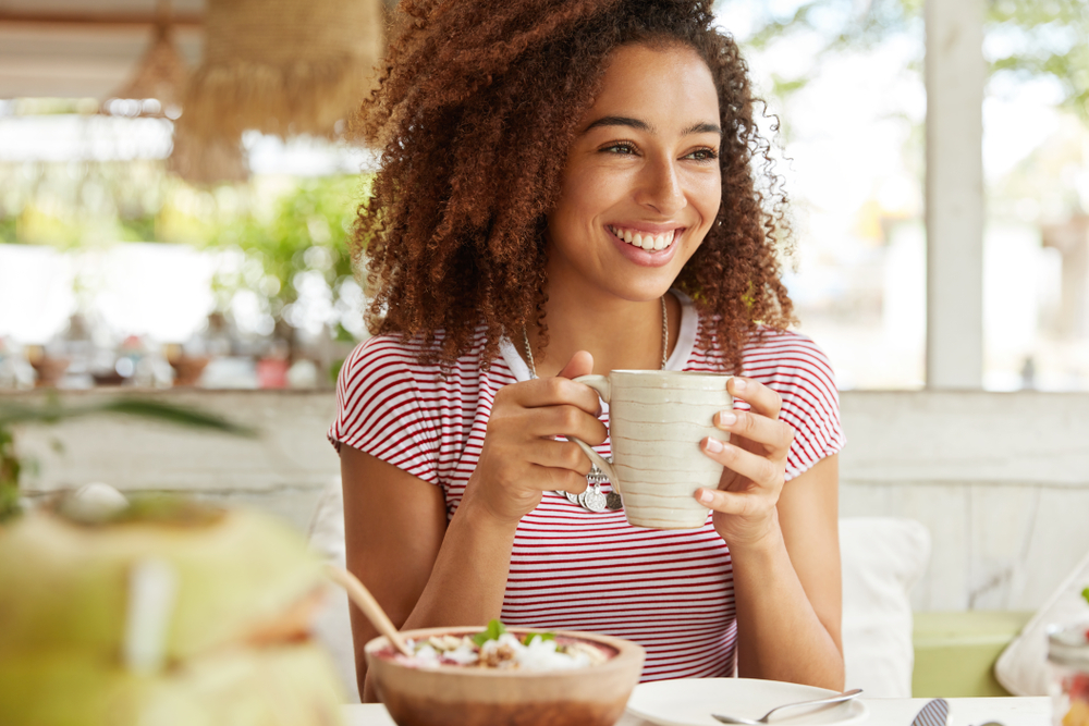 Lady with good skin sipping a coffee