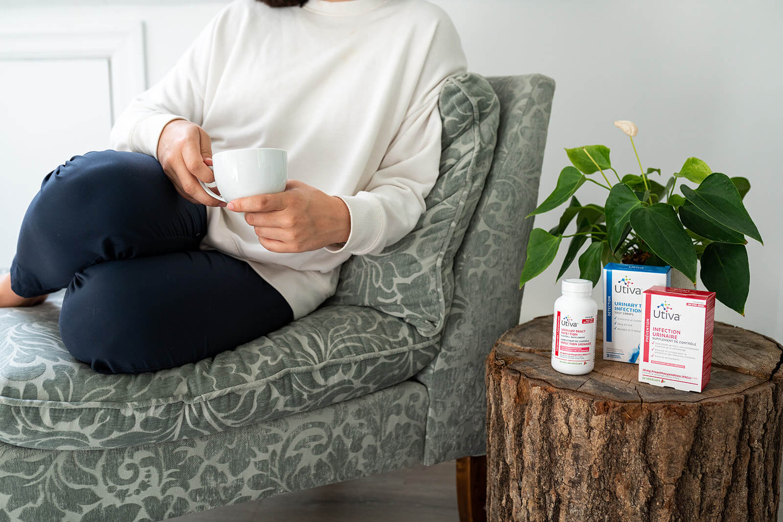 woman sitting on couch beside Utiva products