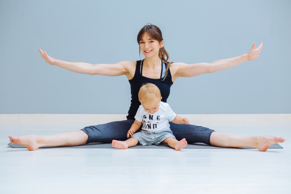 mother stretching with baby