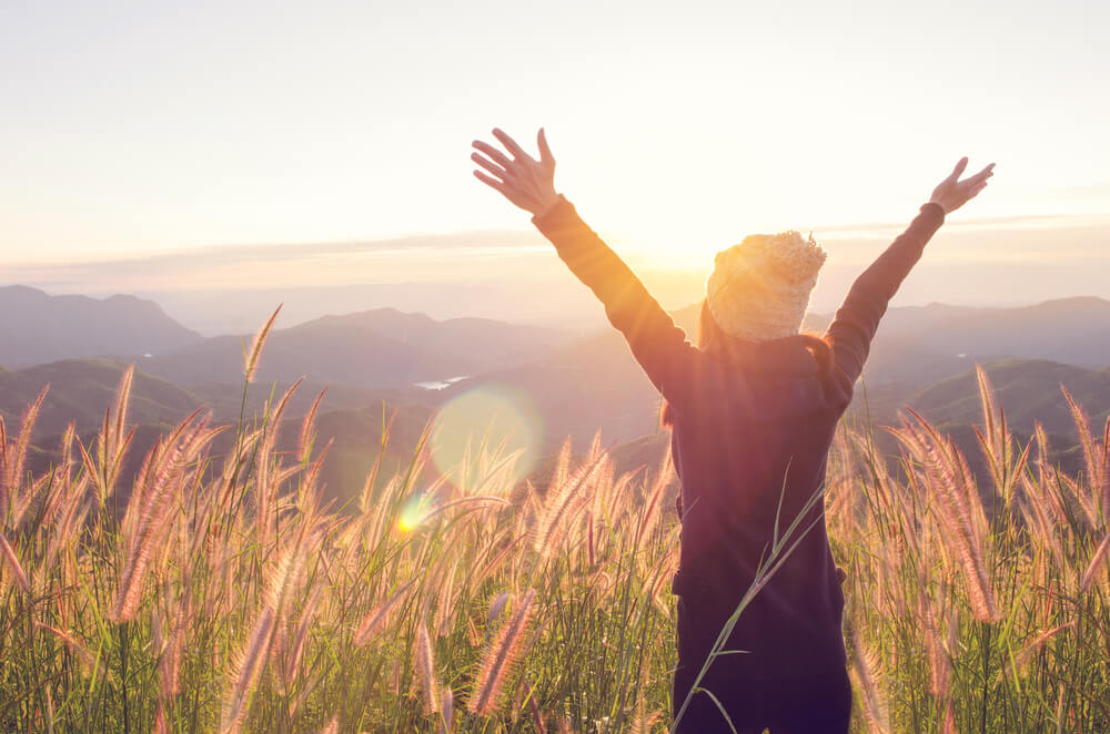 woman on a hike in a sun rise