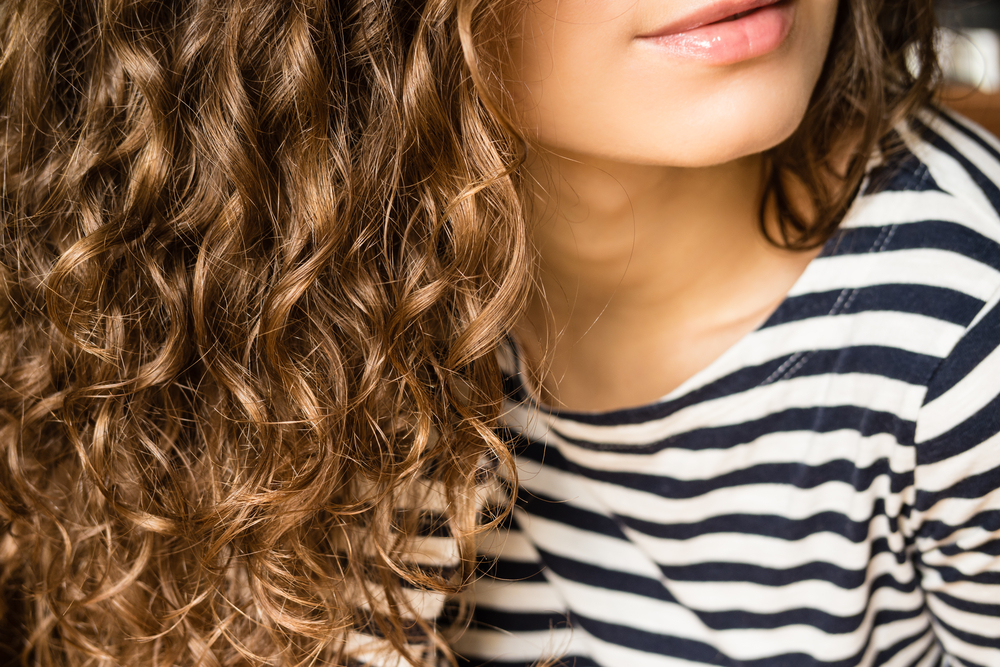 girl with curly hair in stripped shirt