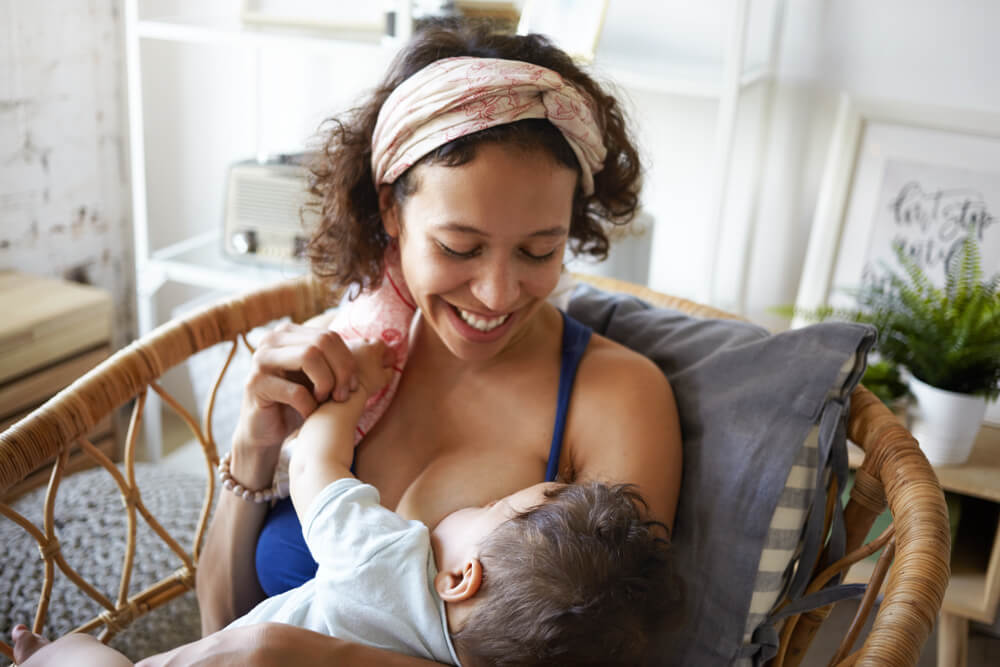 happy woman breastfeeding baby