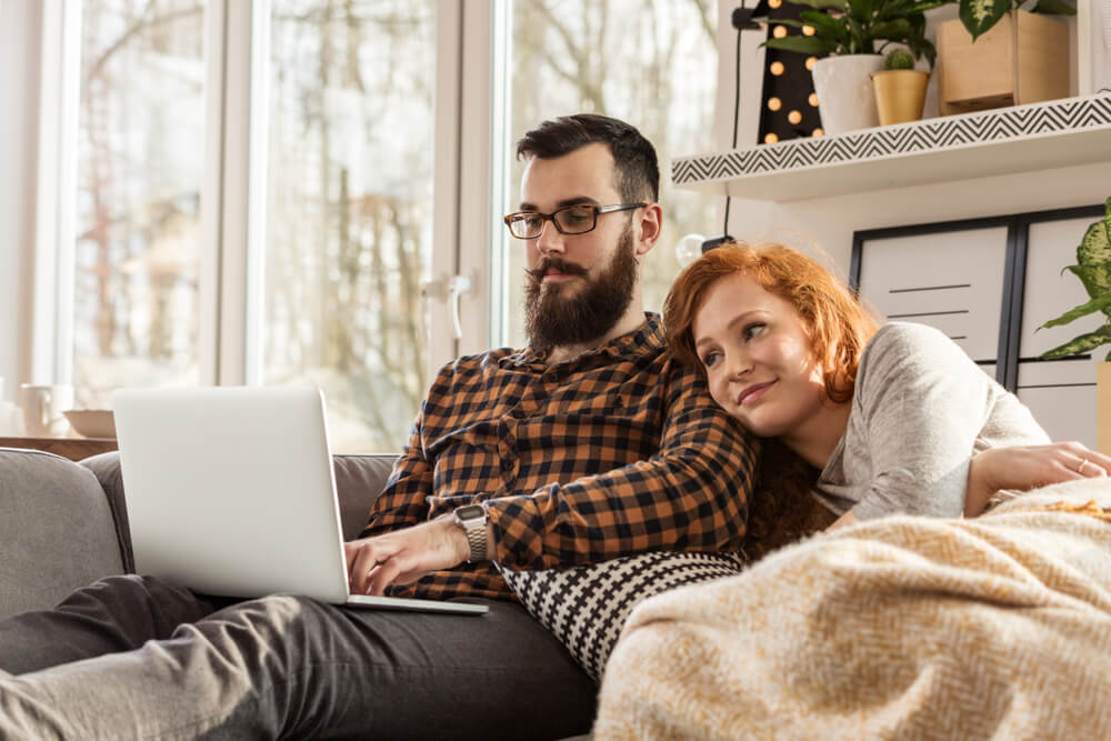 couple in a cozy blanket watching a movie