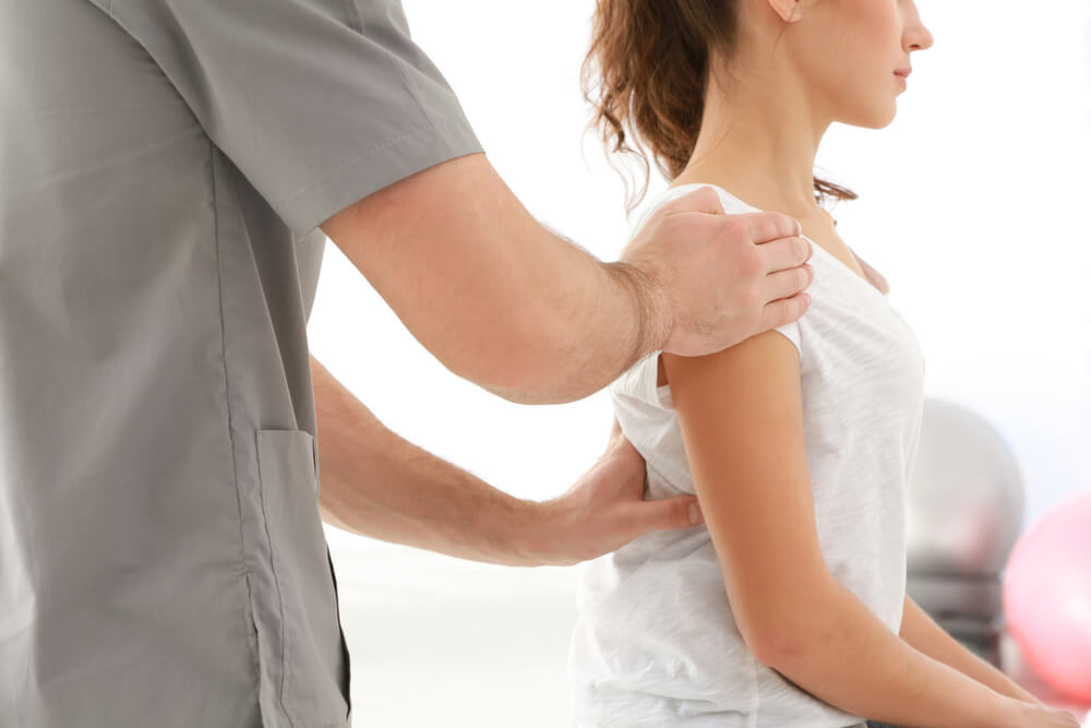 woman getting an adjustment from an osteopath