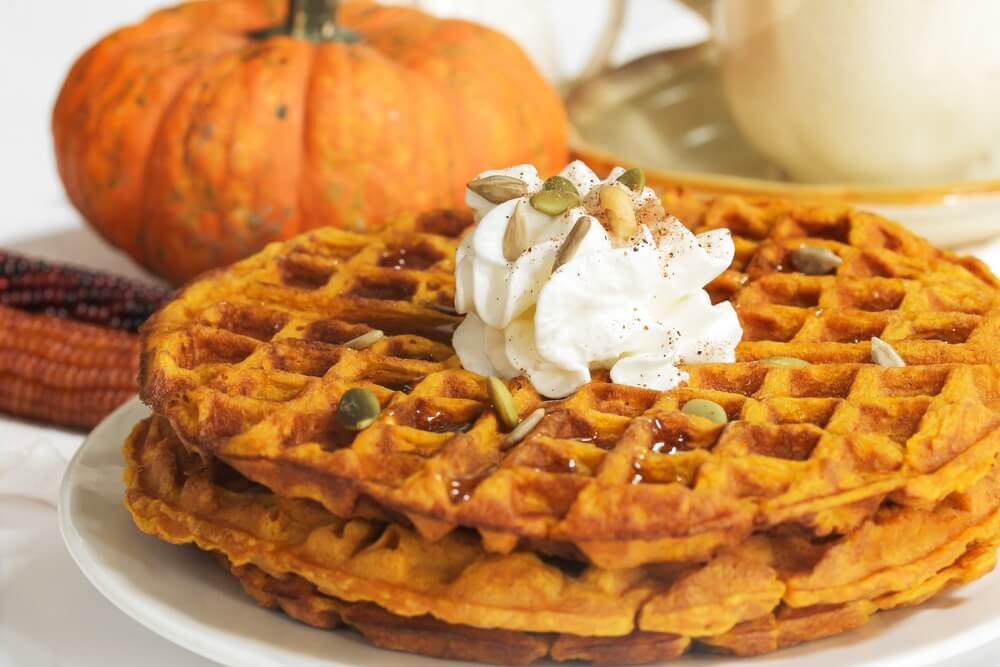 pumpkin waffles with a small pumpkin in the background