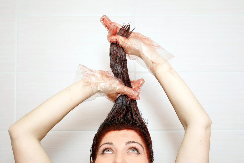 woman colouring her hair in the shower