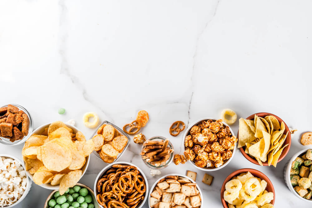 white marble table with snacks in small bowls