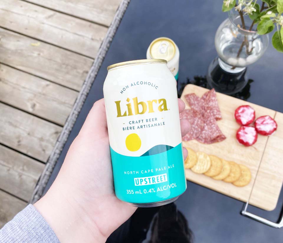 Libra 2 - unedited Hand holding a can of libra outside on a patio