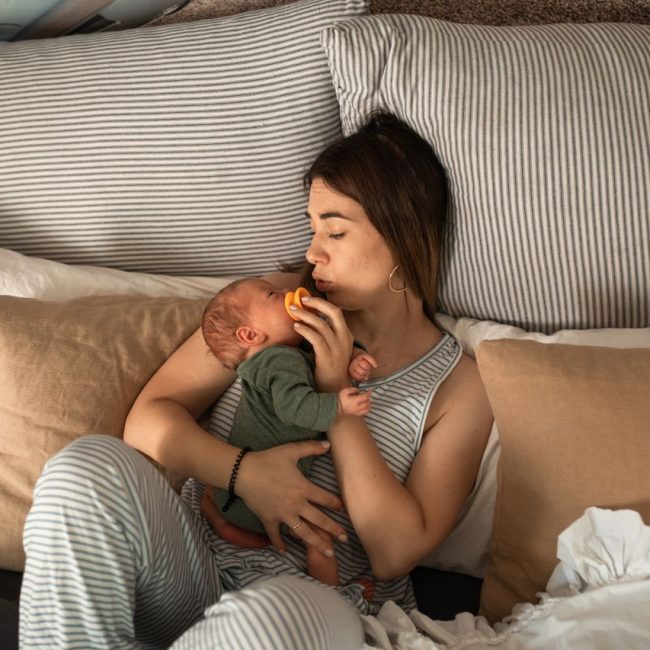 Postpartum mom in bed with baby