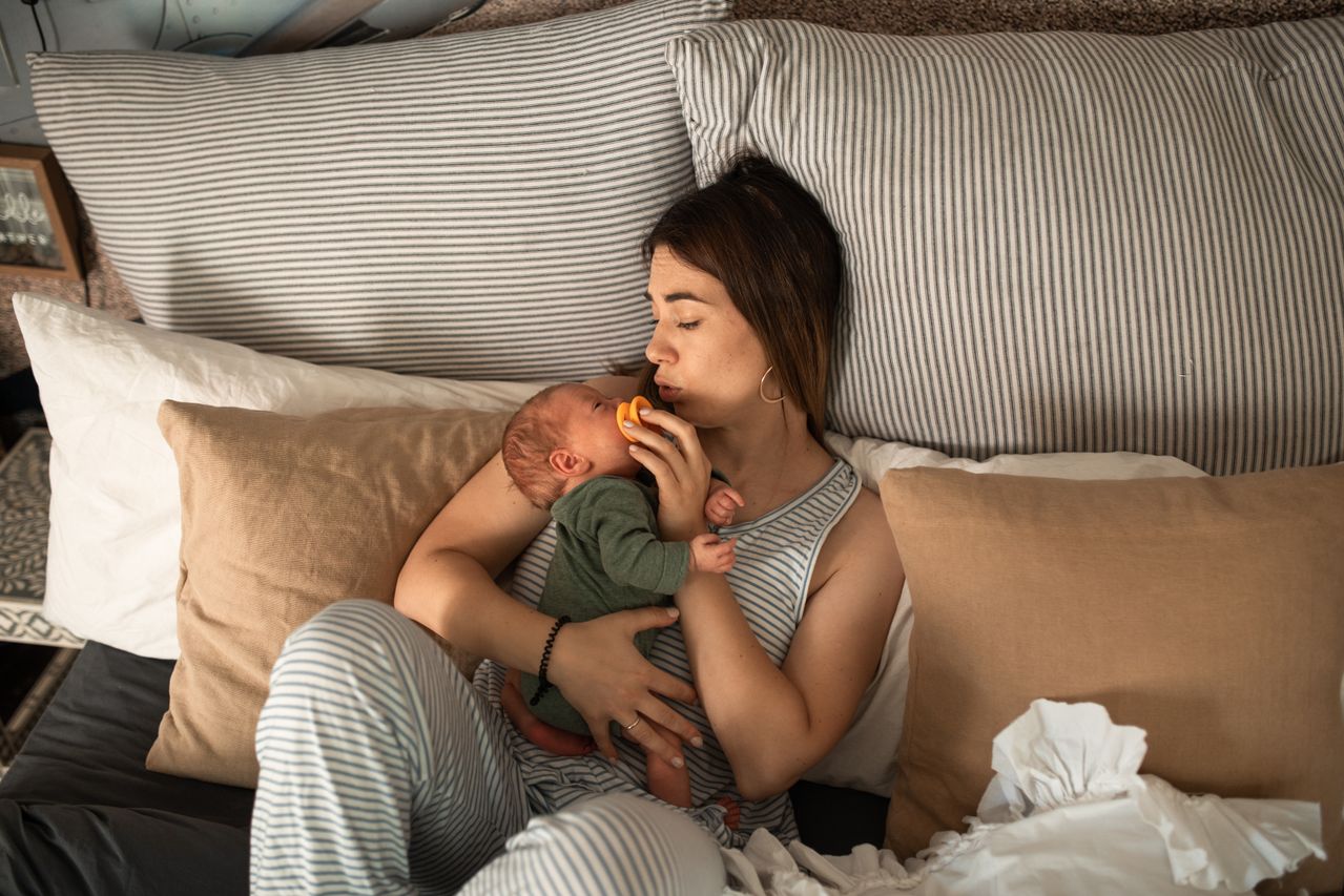 Postpartum mom in bed with baby