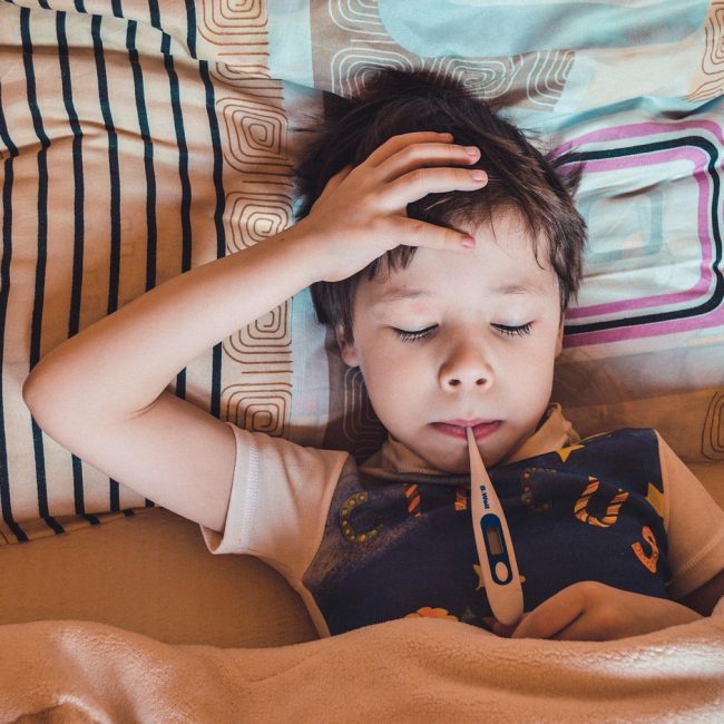 sick child with thermometer