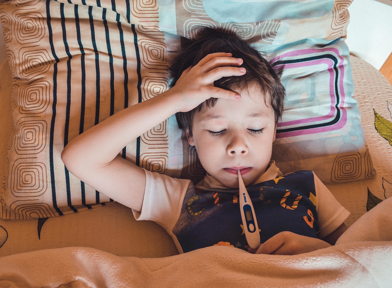 sick child with thermometer