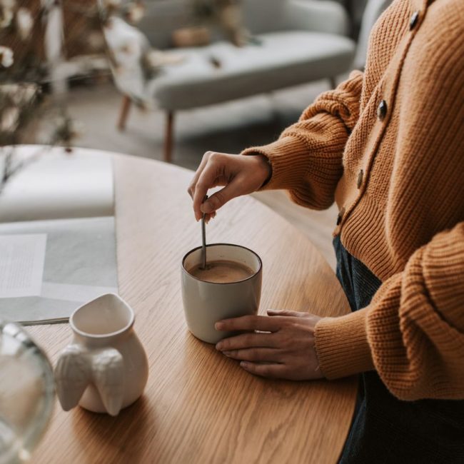 woman stirring hot drink