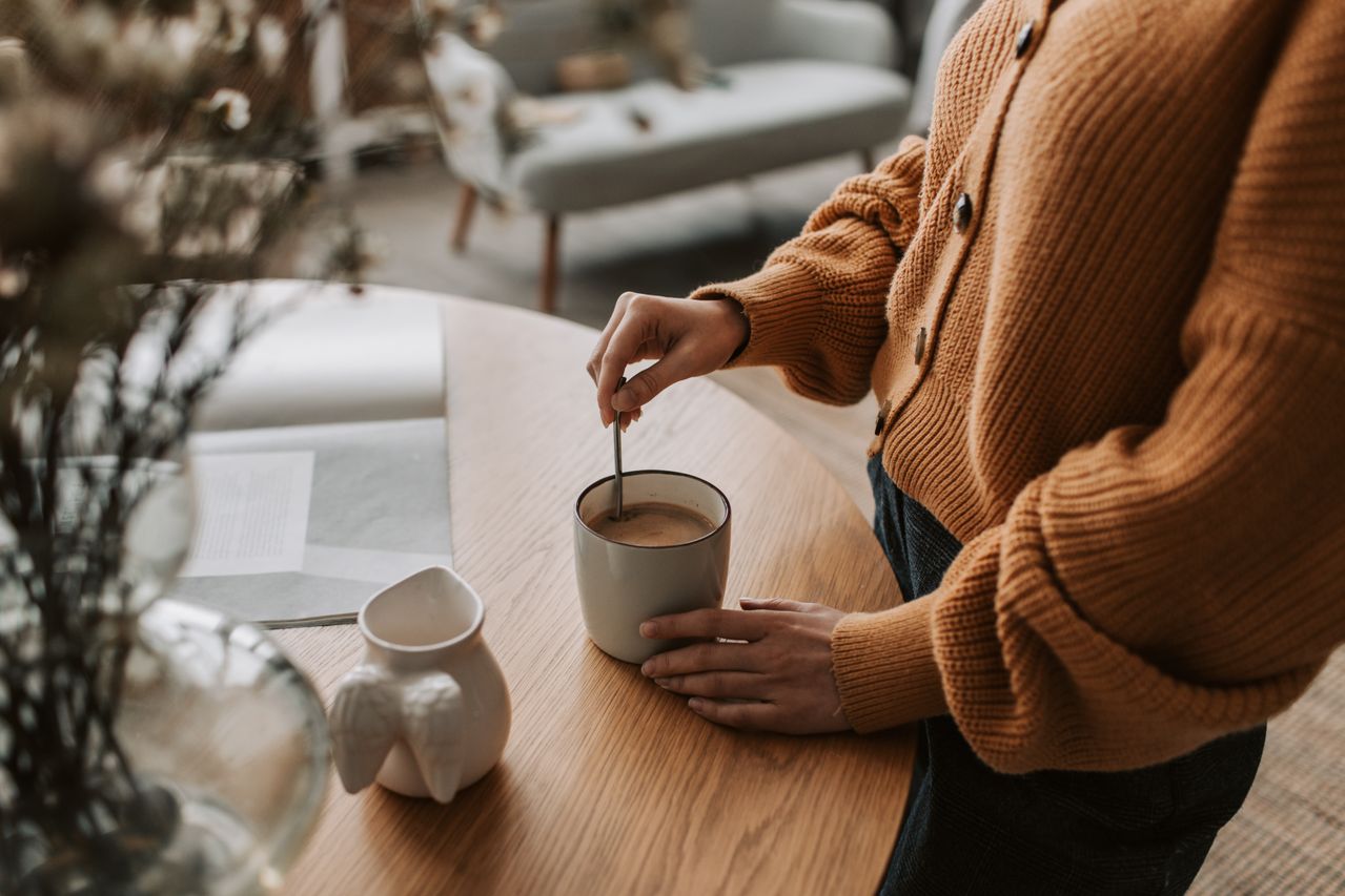woman stirring hot drink